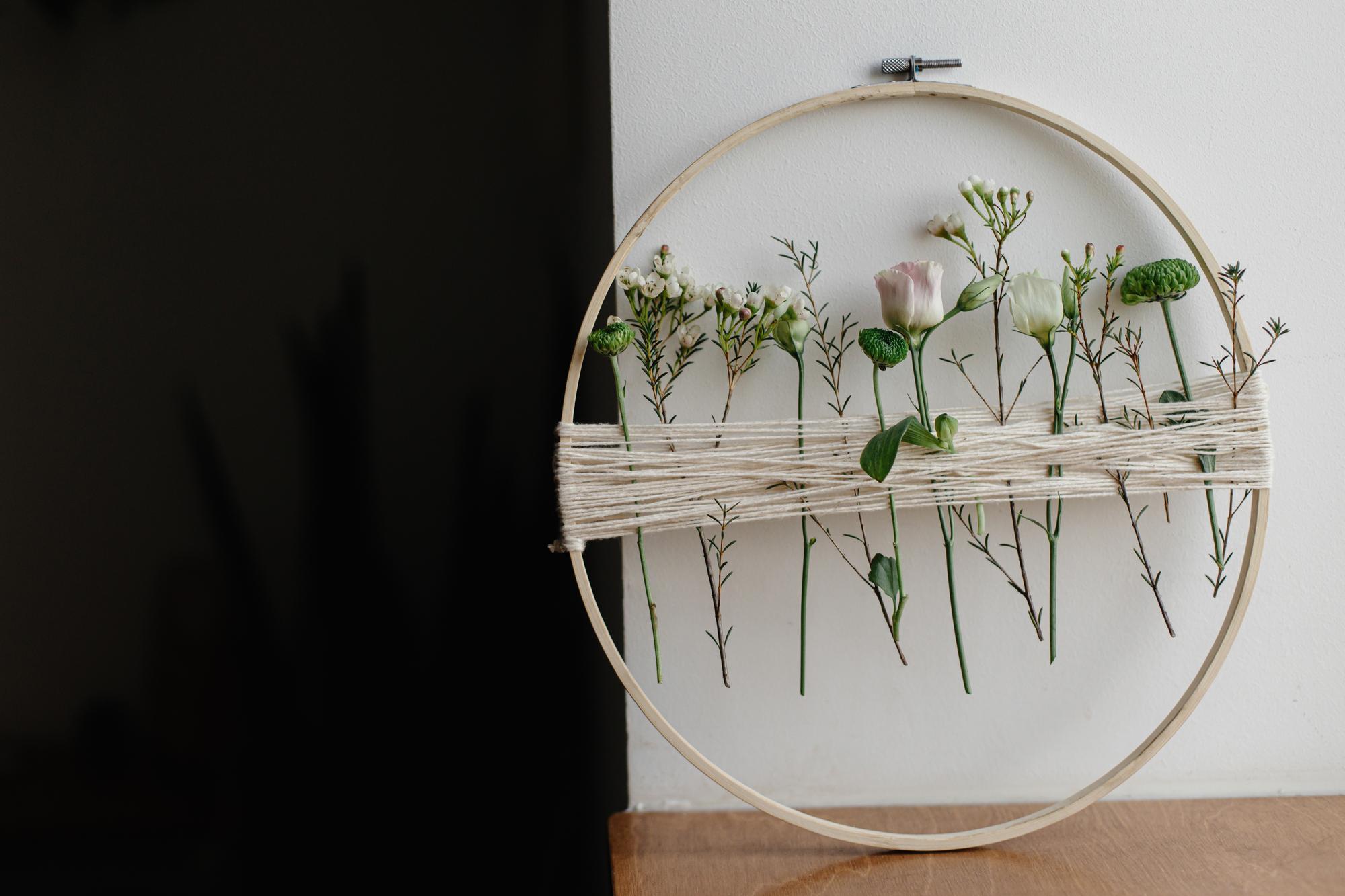 Studio workspace with framed embroidered art